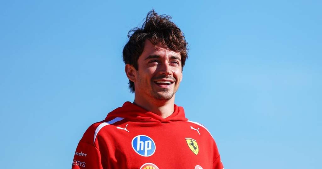 Pembalap Ferrari Charles Leclerc tersenyum di paddock Sirkuit Silverstone Inggris